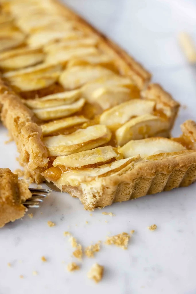 A slice of apple tart with a fork.