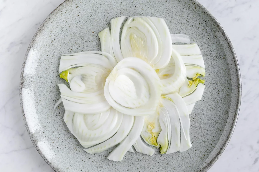 Sliced white onions on a plate.