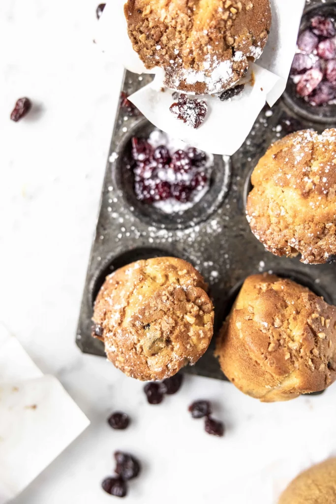 Cranberry muffins in a muffin tin.