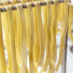 Tagliatelle on a drying rack in a factory.