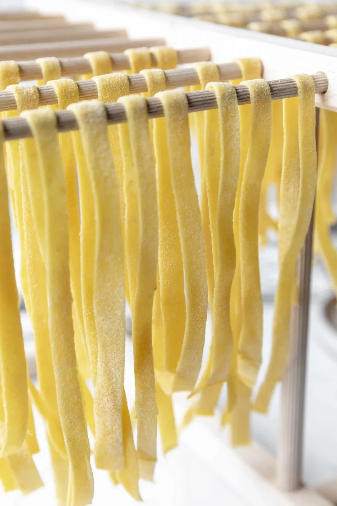 Tagliatelle on a drying rack in a factory.