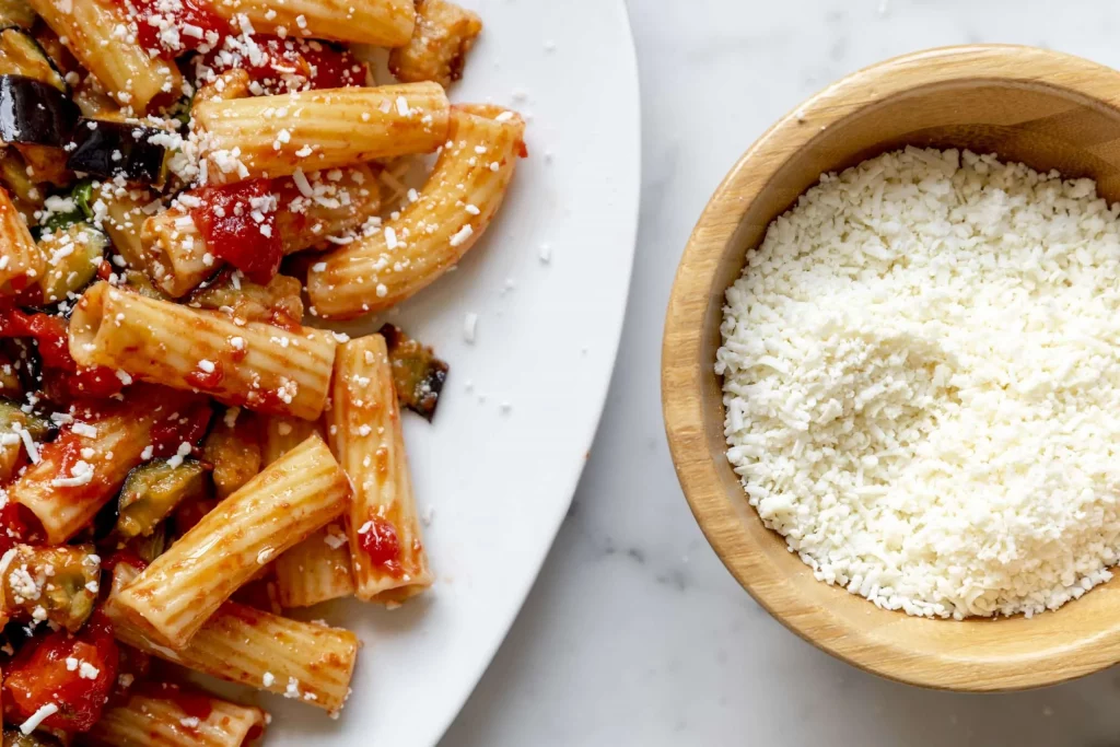 A bowl of pasta and a bowl of ricotta cheese.