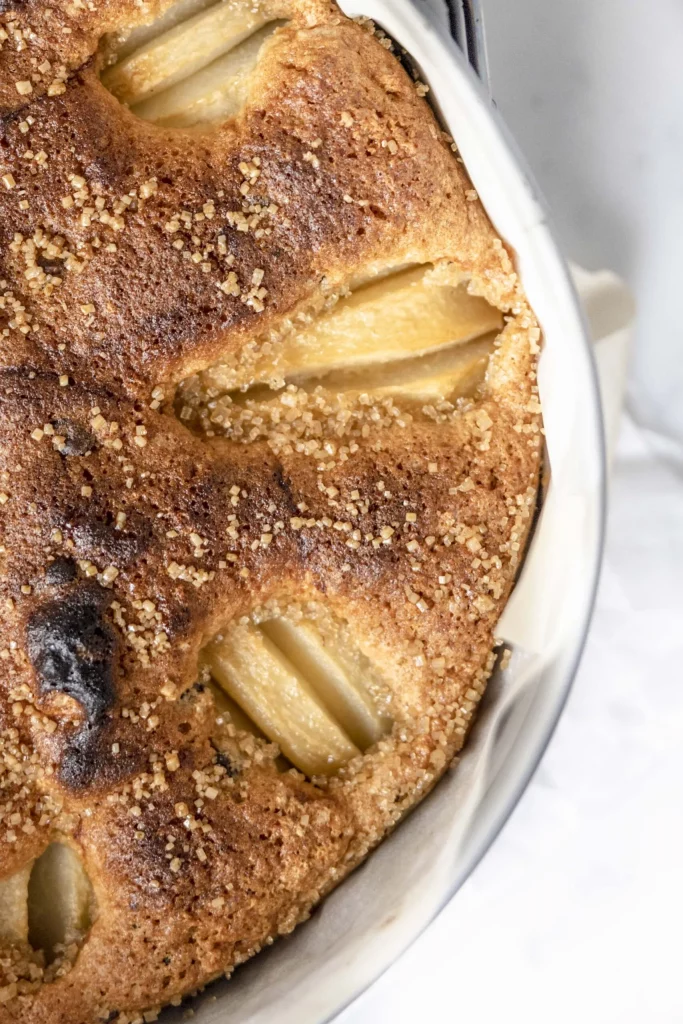 Pear cake in a pan on a table.