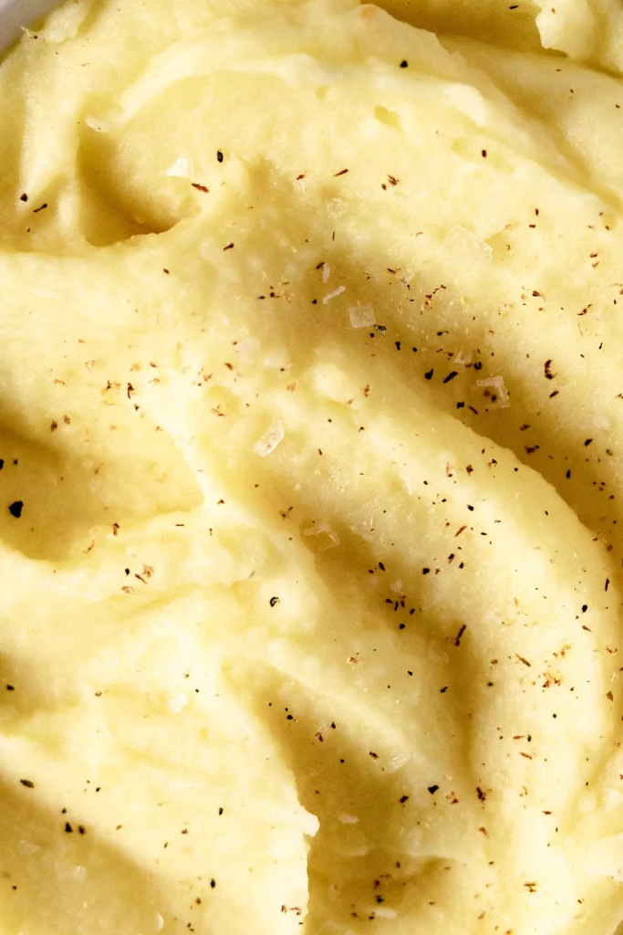 A close up of mashed potatoes in a bowl.