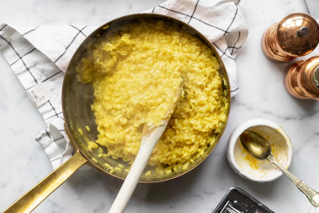 A frying pan filled with yellow rice.
