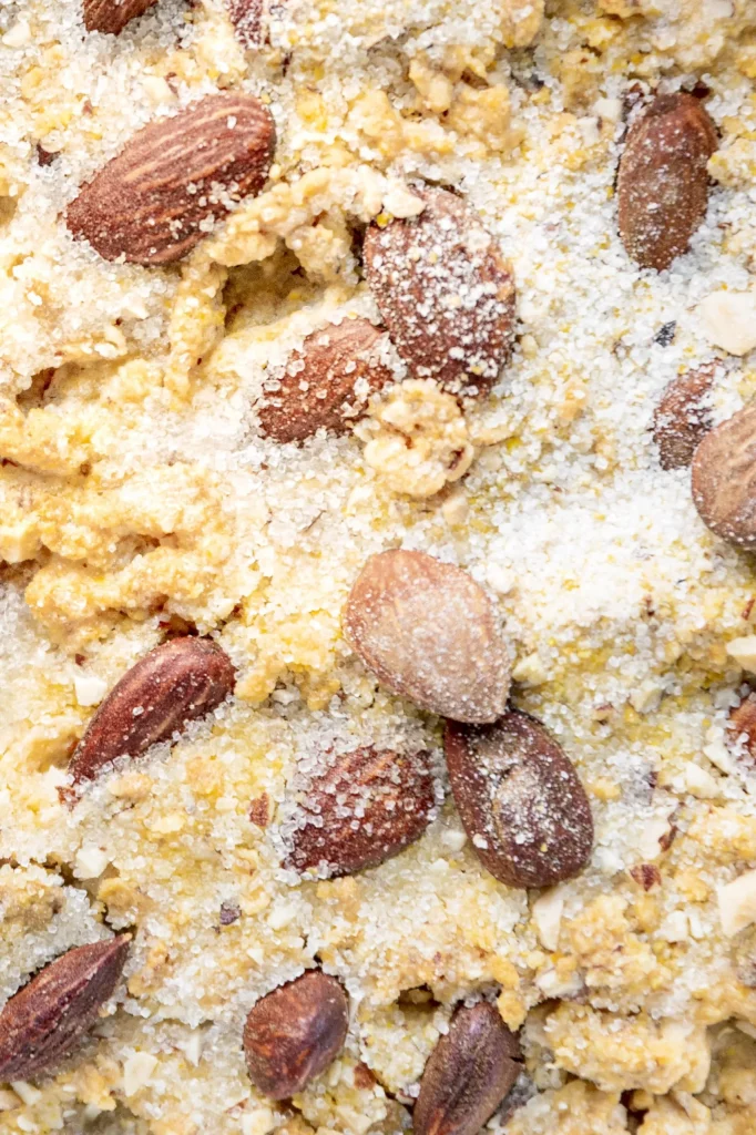 A close up of a dish with almonds and powdered sugar.
