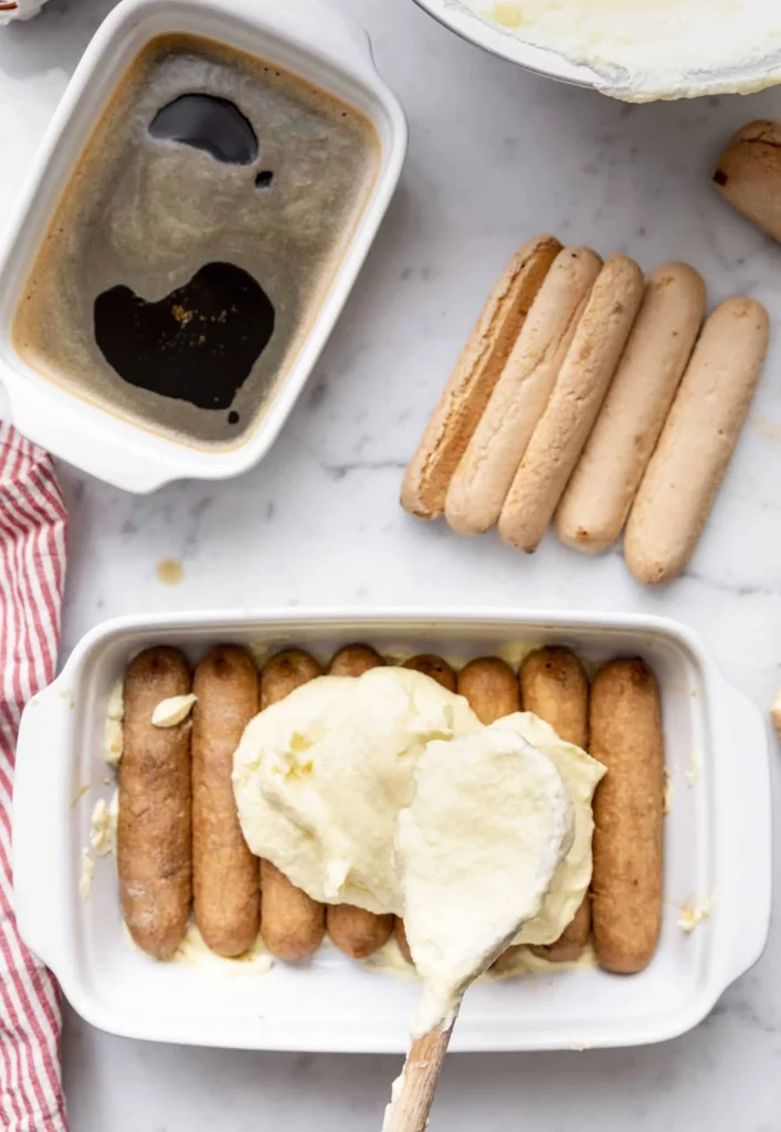 A dish with hot dogs and a bowl of ice cream.