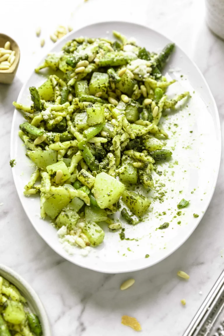 A plate of trofie with pesto and pine nuts.